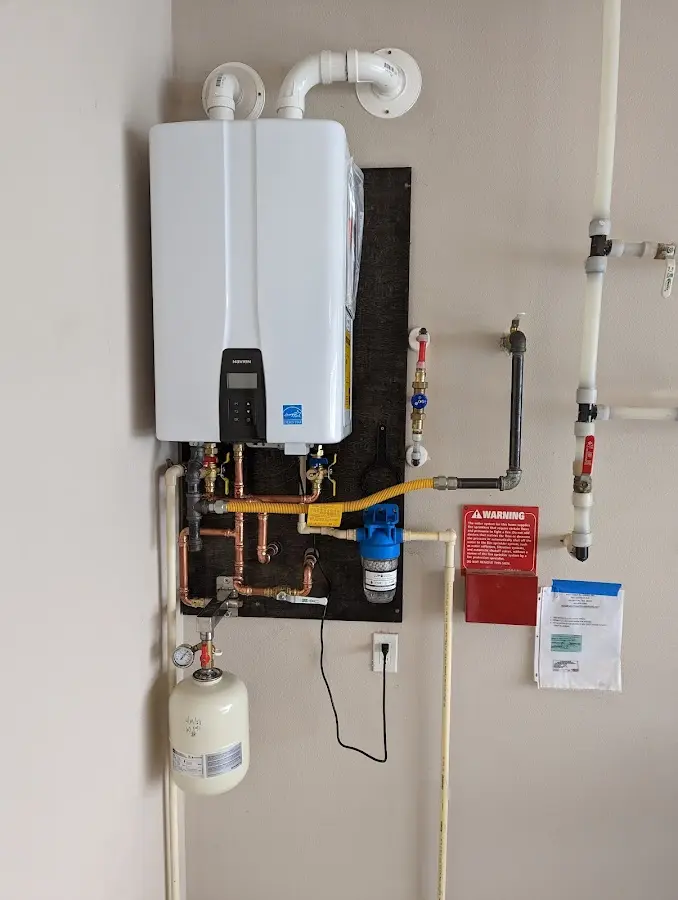 Professional plumber installing copper piping in a Forestville home